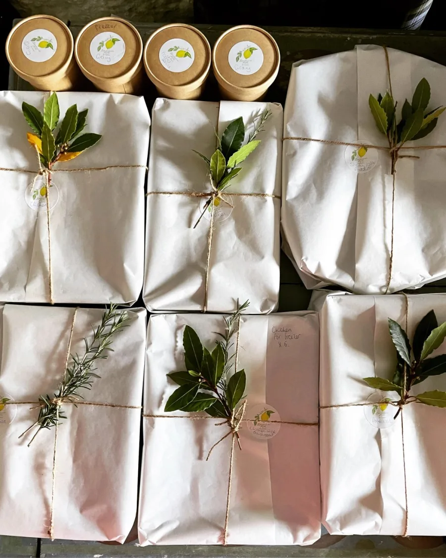 Individual dishes wrapped in paper and tied with sprigs of rosemary and bay, ready for delivery