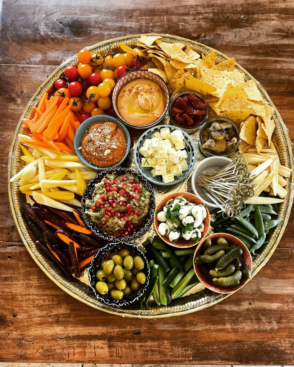 A grazing platter of dips, crudités and cured meats