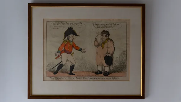 A framed Georgian caricature print on the bathroom wall