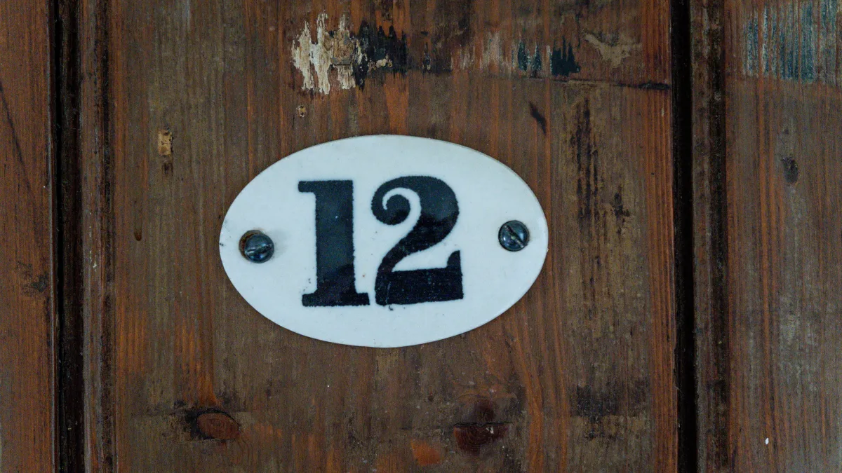 The enamel number twelve plate fixed to the room's panelled pine door
