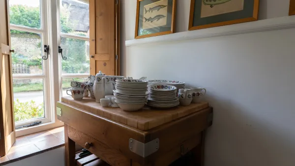 The old pine kitchen dresser at Well Cottage, laden with crockery, pewter jugs and painted pottery