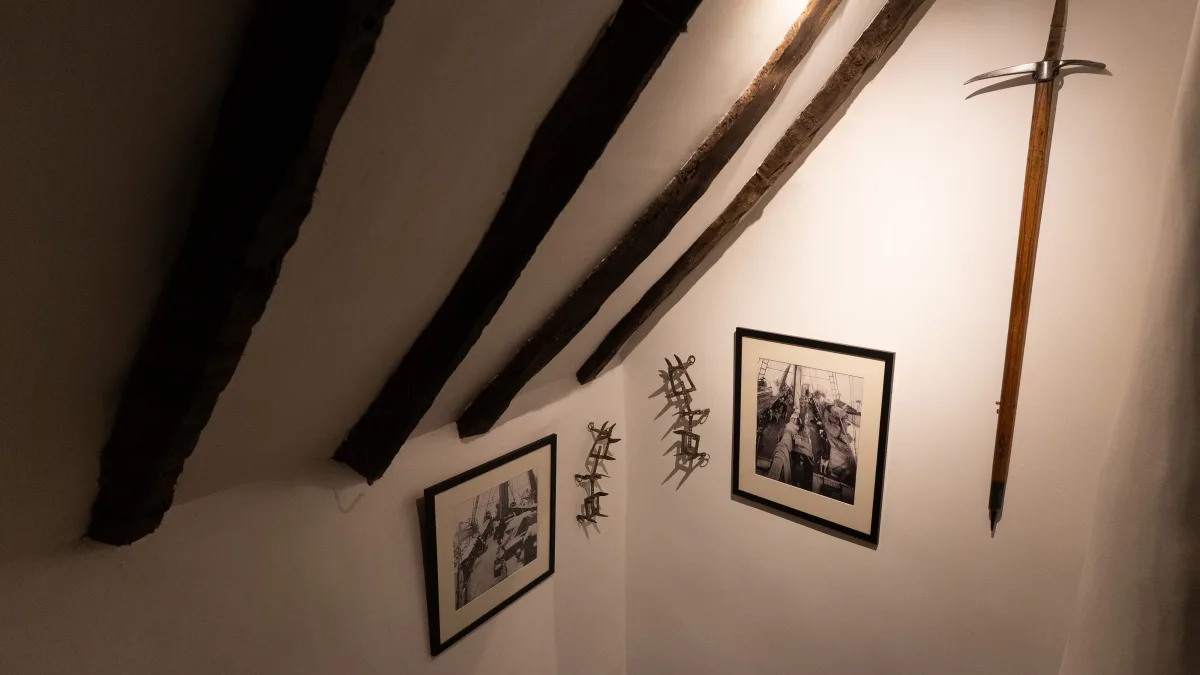 Dark oak beams sweeping down the lime-plaster slope, a vintage ice-axe and framed black-and-white expedition photographs hung along the rafters